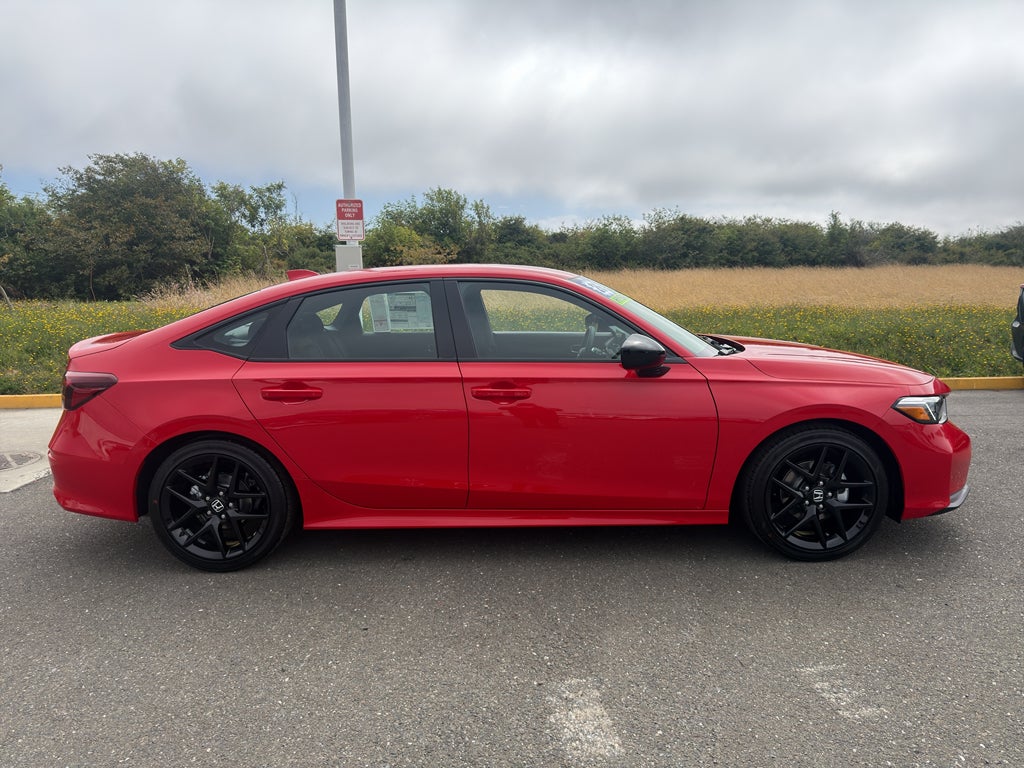 2026 Honda Civic Sport in Rallye Red — front three-quarter view