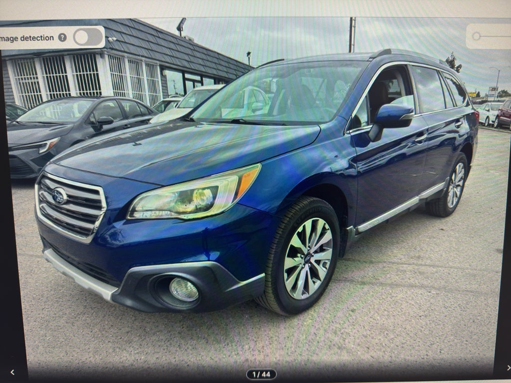 2017 Subaru Outback Touring in Lapis Blue Pearl — front three-quarter view